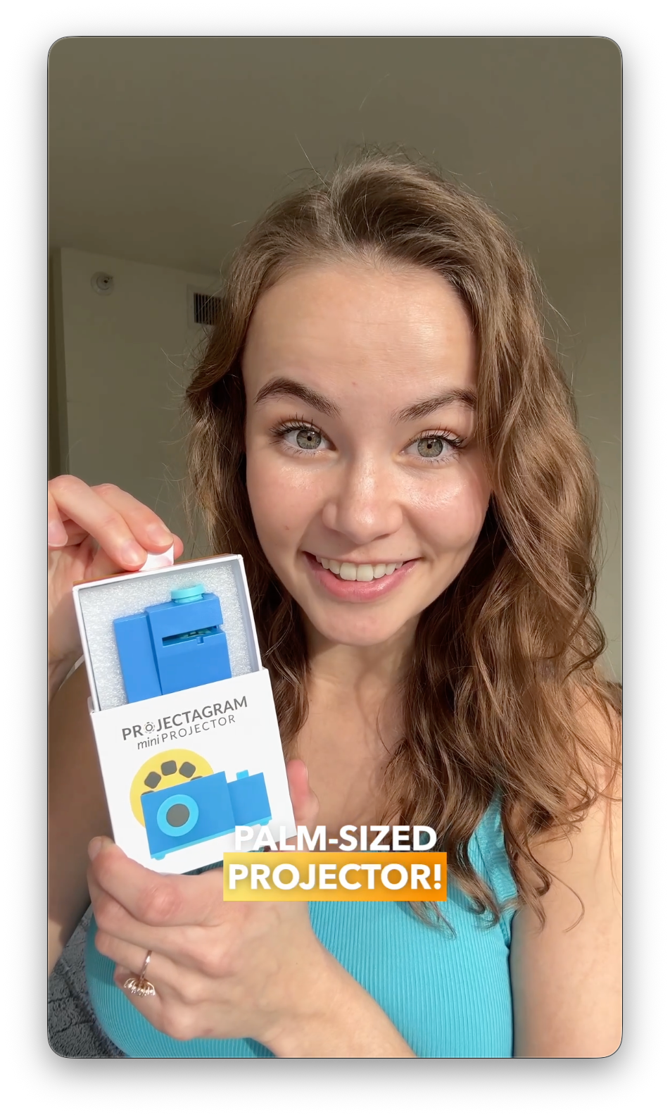 A customer unboxing her palm-sized Projectagram miniProjector